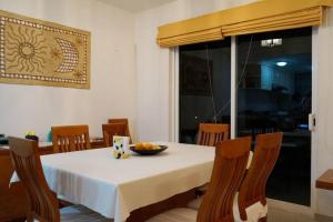 a dining room table with a bowl of fruit on it at Beautiful house in secure subdivision in Acapulco