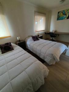 Postel nebo postele na pokoji v ubytování APART HOTEL EN BULNES