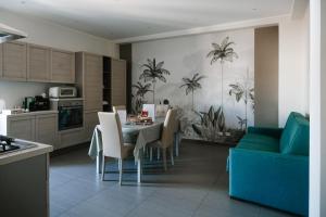 a kitchen and dining room with a table and chairs at Carmina in Brolo