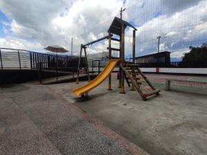 a playground with a slide at a park at Apartamento frente a la montaña en Armenia Quindio - 1 Dormitorio Piso 11 in Armenia