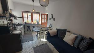 a living room with a couch and a kitchen at Annushka Apartman in Sarud