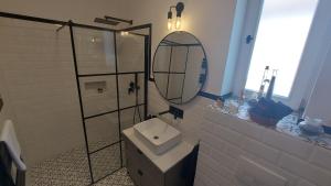 a bathroom with a toilet and a mirror at Annushka Apartman in Sarud +28 photos