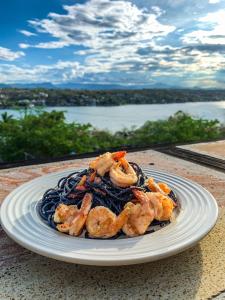 a plate of food with shrimp on a table at La Casa del Guamúchil in Tequesquitengo