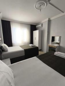 a hotel room with two beds and a television at Rize Akarsu Apart in Rize +14 photos