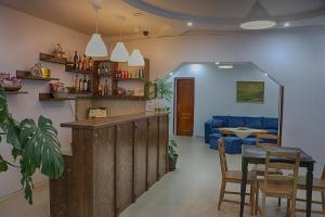 a living room with a bar and a blue couch at Casa Camelia in Săcel