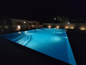 a swimming pool lit up at night at MiLaz Apartment in Kotor