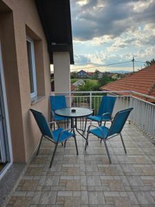a patio with a table and chairs on a balcony at Apartman L&L in Sarajevo