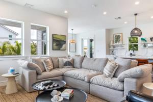 a living room with a couch and a table at New The Windrose House - Pool & Pets in Key West