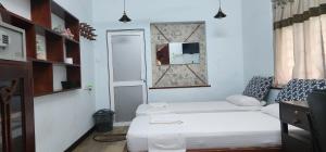 Postel nebo postele na pokoji v ubytování CHARAKAMA Guest Bungalow - GAMPAHA