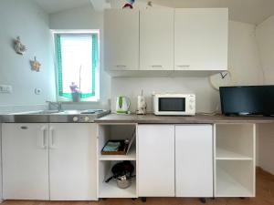 Kuchyň nebo kuchyňský kout v ubytování Apartments G&G