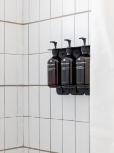 a bathroom with three water bottles hanging on a wall at The Outpost Rocky Mountains in Estes Park