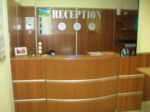 a reception desk with clocks on the wall at Hotel Elica in Varna City