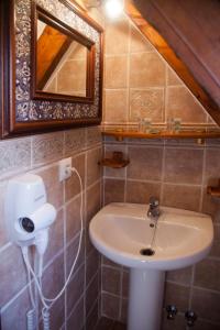 a bathroom with a sink and a mirror at Hostal Mar de Frente in Los Caños de Meca
