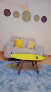 a living room with a couch and a yellow coffee table at Natna's 1 bedroom near Bofa Beach in Tezo