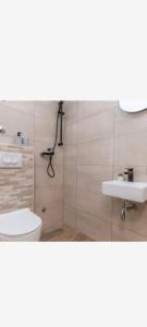 a bathroom with a toilet and a sink at Villa Marina in Biograd na Moru +10 photos