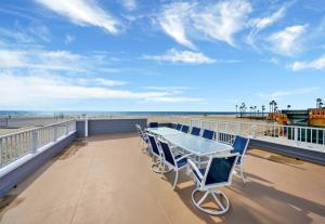 a table and chairs on a balcony overlooking the beach at 1404 W Oceanfront C in Newport Beach