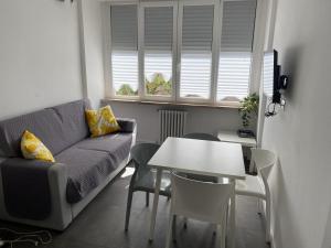 a living room with a couch and a table at Luxury central apartments in Pisa