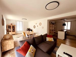 a living room with a couch and a table at Villa André à Nîmes in Nîmes