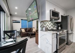 a kitchen and living room with a stove and microwave at 5 Bedrooms in Newport Beach