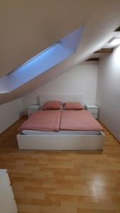 a bedroom with a bed in a attic at útulný podkrovní byt v centru Třebíče in Třebíč +19 photos