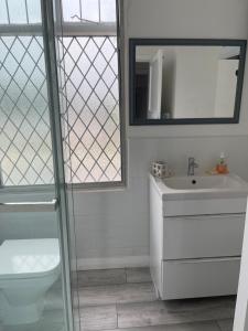 a bathroom with a toilet and a sink and a mirror at Beautiful home in central Bishop Auckland town in Bishop Auckland