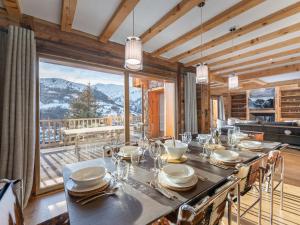 a dining room with a table and a large window at Chalet avec jacuzzi, proche des pistes, pour 10 personnes - FR-1-570-20 in Saint-Martin-de-Belleville