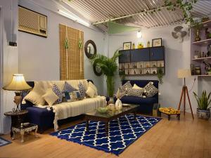 a living room with a couch and a table at Aayam Art Residency in Jaipur