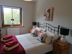 a bedroom with a bed with pillows and a window at The Brooks in Newcastle