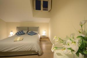 a bedroom with a bed with two blue pillows at B&B Portanova in Salerno