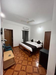 a bedroom with a bed and a tv in it at Hotel Sai Deep By AK Hospitality in Calangute