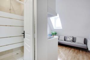 a door leading into a living room with a couch at Charming apartment - 1BR-3P -Trocadero in Paris