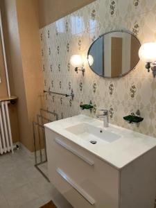 a bathroom with a white sink and a mirror at Villa Catherine in Olivet +14 photos