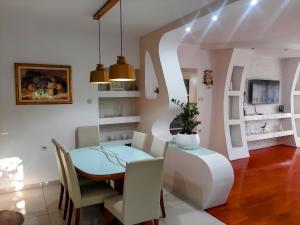 a dining room with a table and chairs at Guest House NO 13 in Mostar