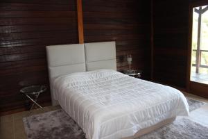 a white bed in a room with wooden walls at Lake Prestige Villa Castelo de Bode, Tomar in Tomar +61 photos