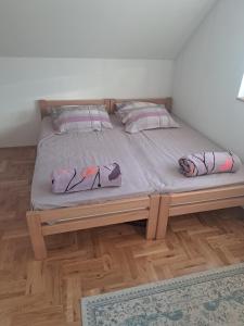 a bed with two pillows on it in a room at Misevici vikendica in Sarajevo