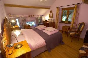 a bedroom with a large bed and a desk with a lamp at Het Pachthof in Borlo