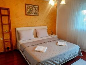a bedroom with a bed with two towels on it at Guest House NO 13 in Mostar +54 photos