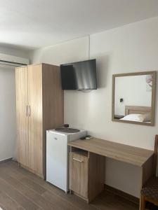 a kitchen with a white refrigerator and a mirror at Apartmani Juković in Ulcinj