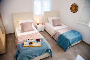 a room with two beds with a tray of food on it at Aroura Maisonette Spetses 4BR in Spetses