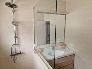 a bathroom with a sink and a shower at Casa Playa Chica Lanzarote in Puerto del Carmen +57 photos