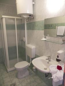 a bathroom with a toilet and a sink at Motel Majolka in Ptuj