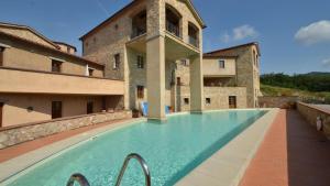 a large swimming pool in front of a building at Il Balcone in Gaiole in Chianti