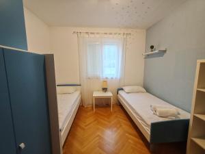 Postel nebo postele na pokoji v ubytování Apartment EMMI