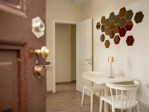 a room with a table and chairs and a door at Dimora dei Mercanti Suites - New Premium Rooms in Turin