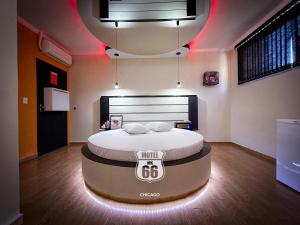 a bedroom with a bed with a sign on it at MOTEL MK 66 in Mairinque