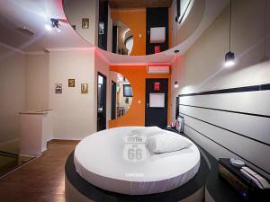 a room with a large white bed in the middle at MOTEL MK 66 in Mairinque