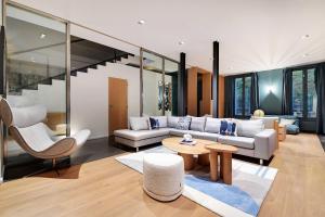 a living room with a couch and a table at Fabulous House - a Gem in Chic Western Paris in Paris