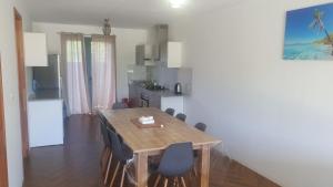 a kitchen and dining room with a table and chairs at The confidence in Mahébourg +2 photos