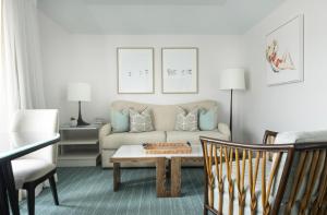 a living room with a couch and a coffee table at Chatham Bars Inn in Chatham
