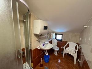 a bathroom with a toilet and a sink and a shower at Apartments Mudrić in Herceg-Novi +32 photos